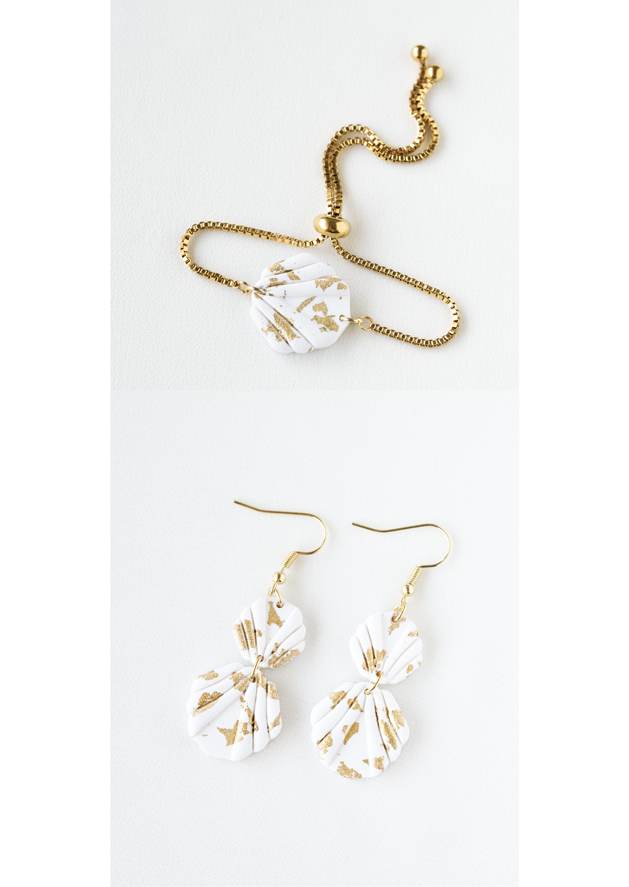 Polymer clay earring and bracelet jewelry set with white and gold leaf accented shell shaped pieces on a white background.