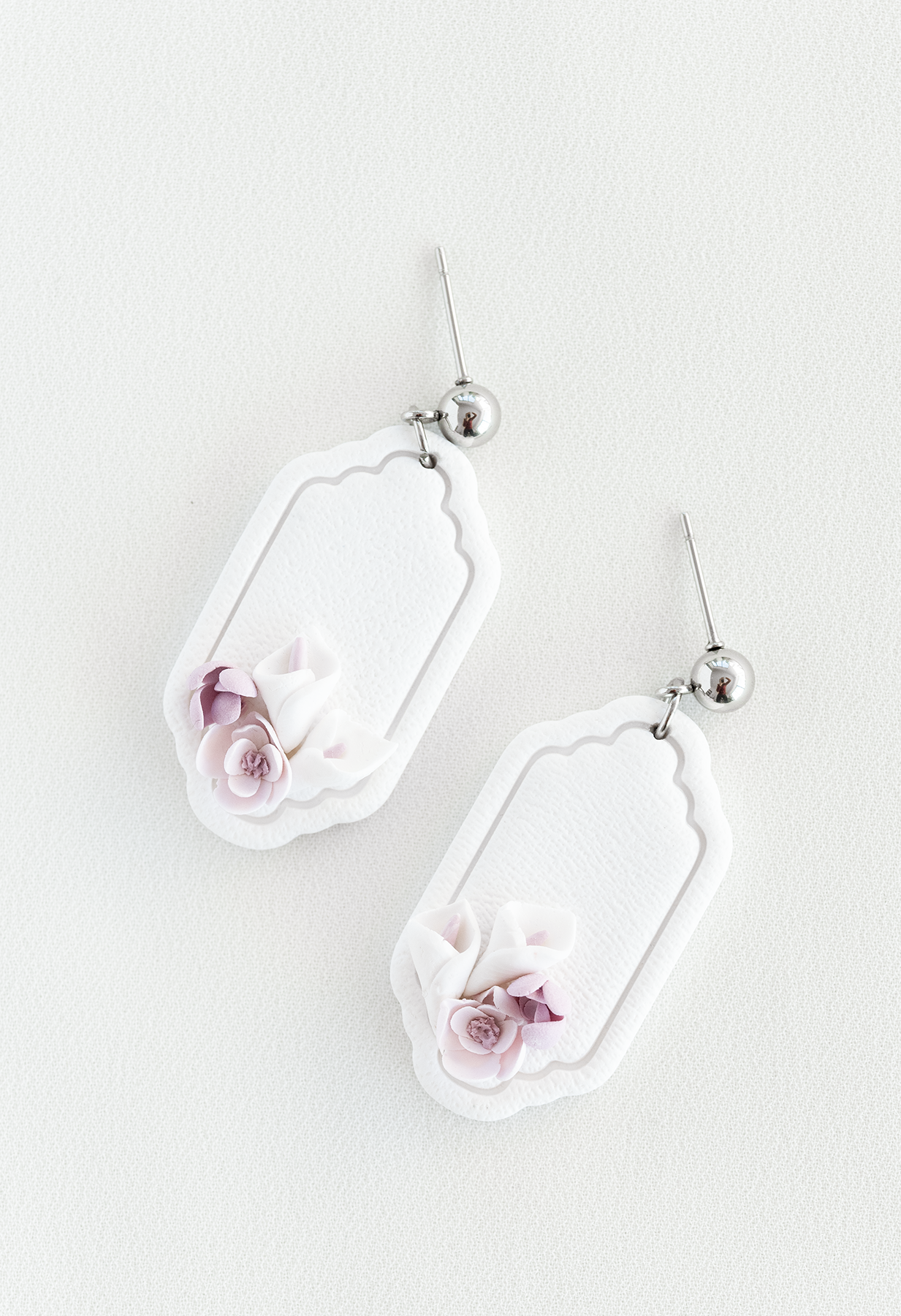 Pair of earrings with floral design on a light background, flower earrings, perfect for weddings and everyday wear.