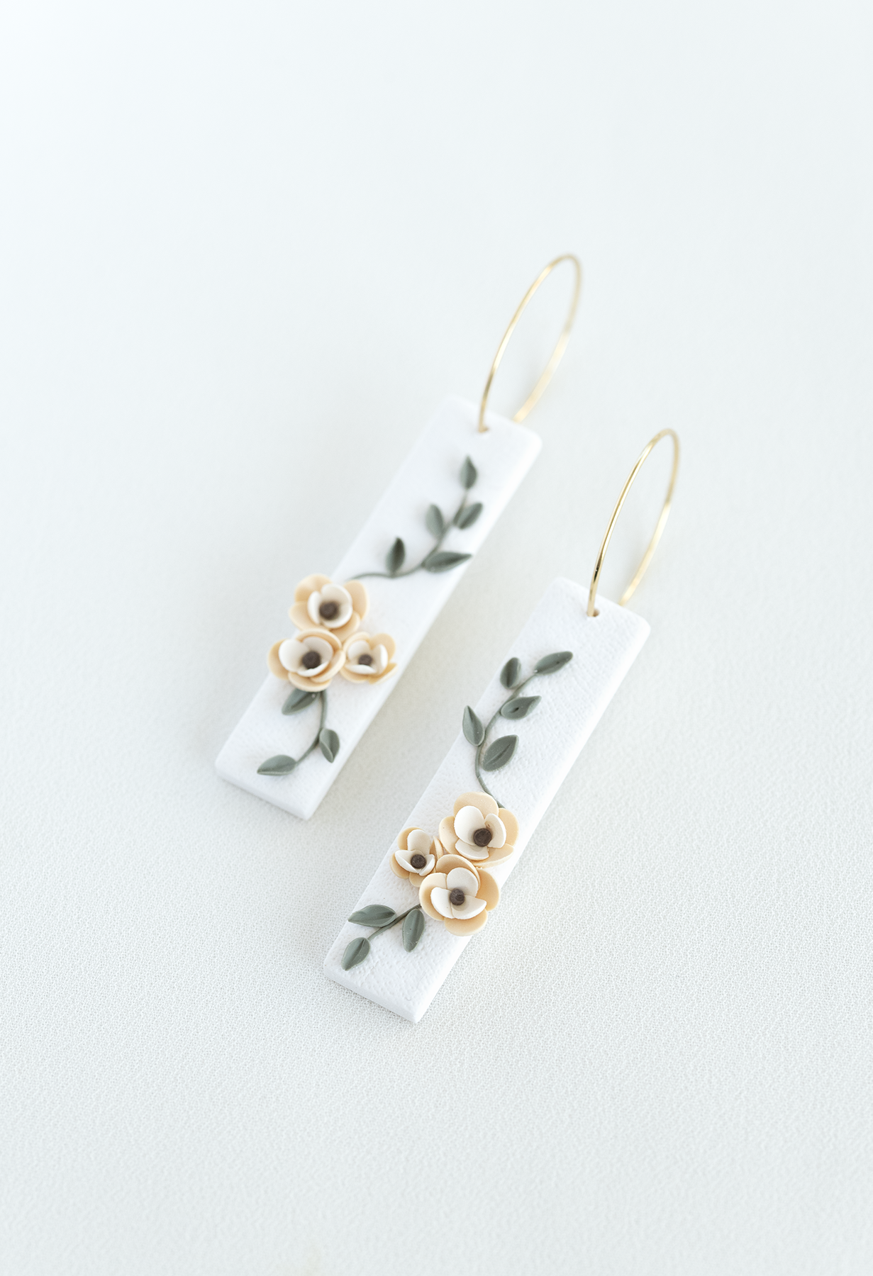 Pair of earrings with floral design on a white background, flower earrings, perfect for weddings and everyday wear.
