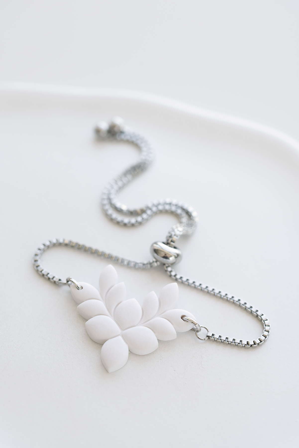 ANTIGUA hand-crafted adjustable stainless steel bracelet with white leaf polymer clay ornament, made in Dubai