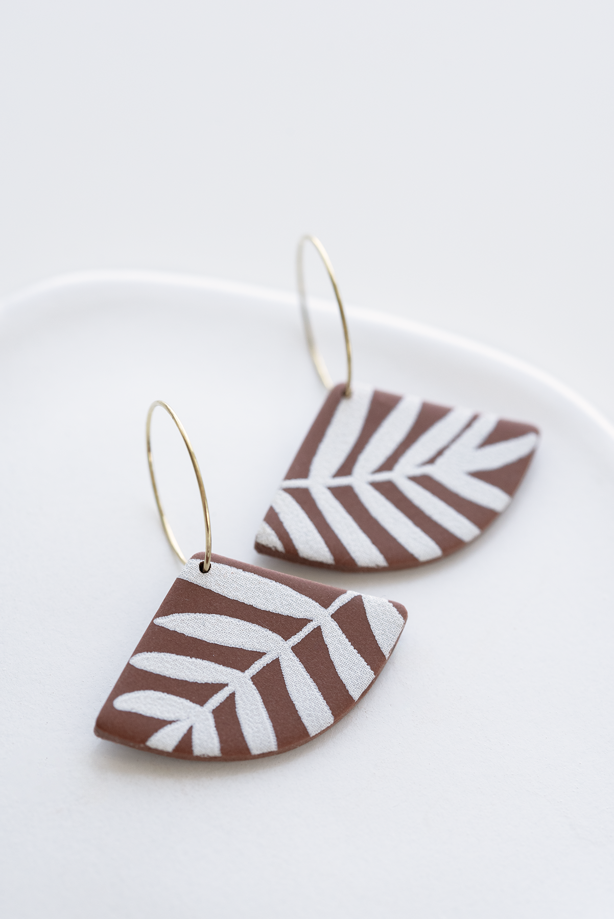 ATLANTA polymer clay hoop earrings, gold plated stainless steel, brownie color with white leaf pattern