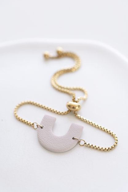 MADEIRA hand-crafted adjustable gold plated stainless steel bracelet with pale oat arch polymer clay ornament, made in Dubai