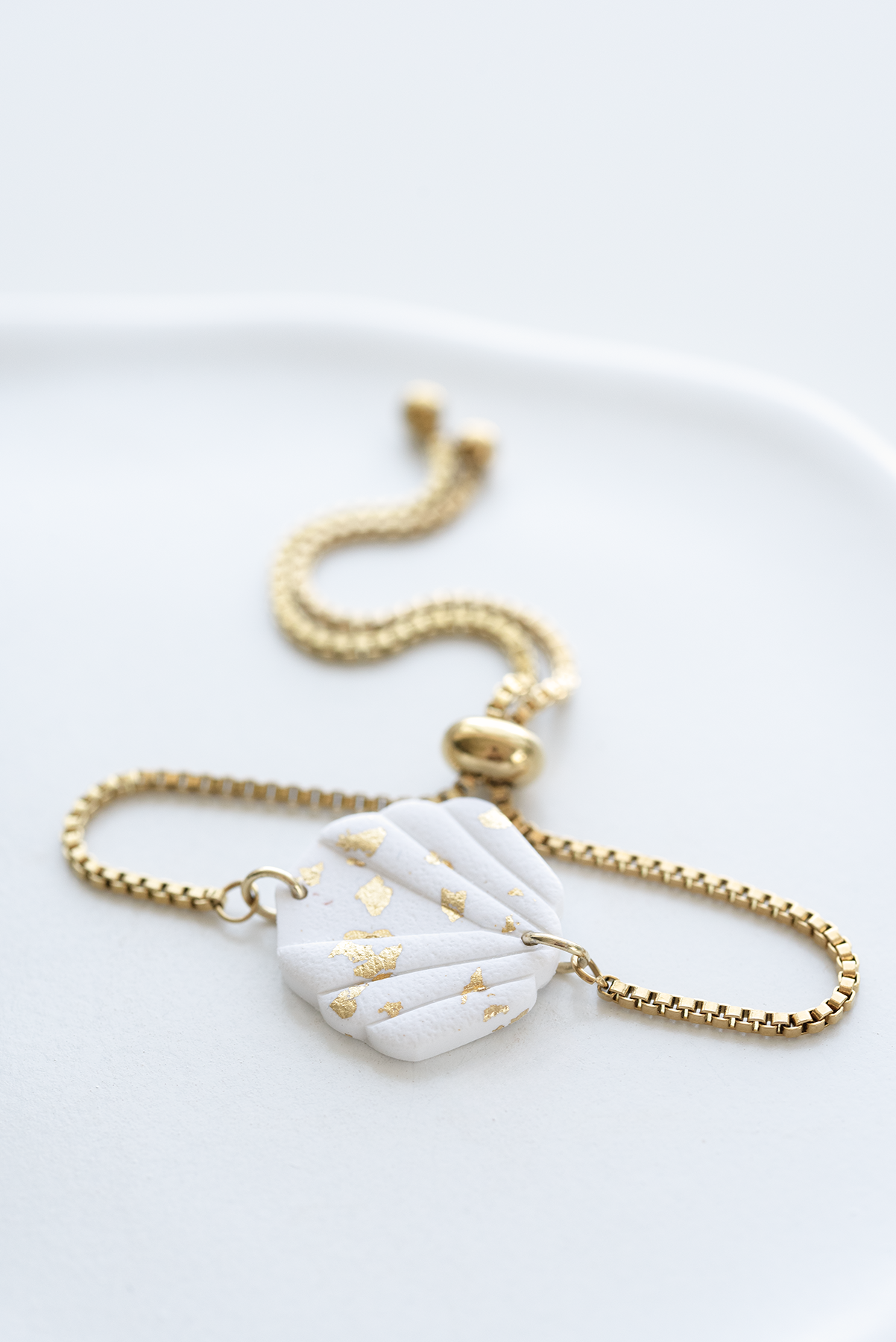 SICILY hand-crafted gold plated stainless steel slider bracelet with white and gold leaf polymer clay ornament, made in Dubai