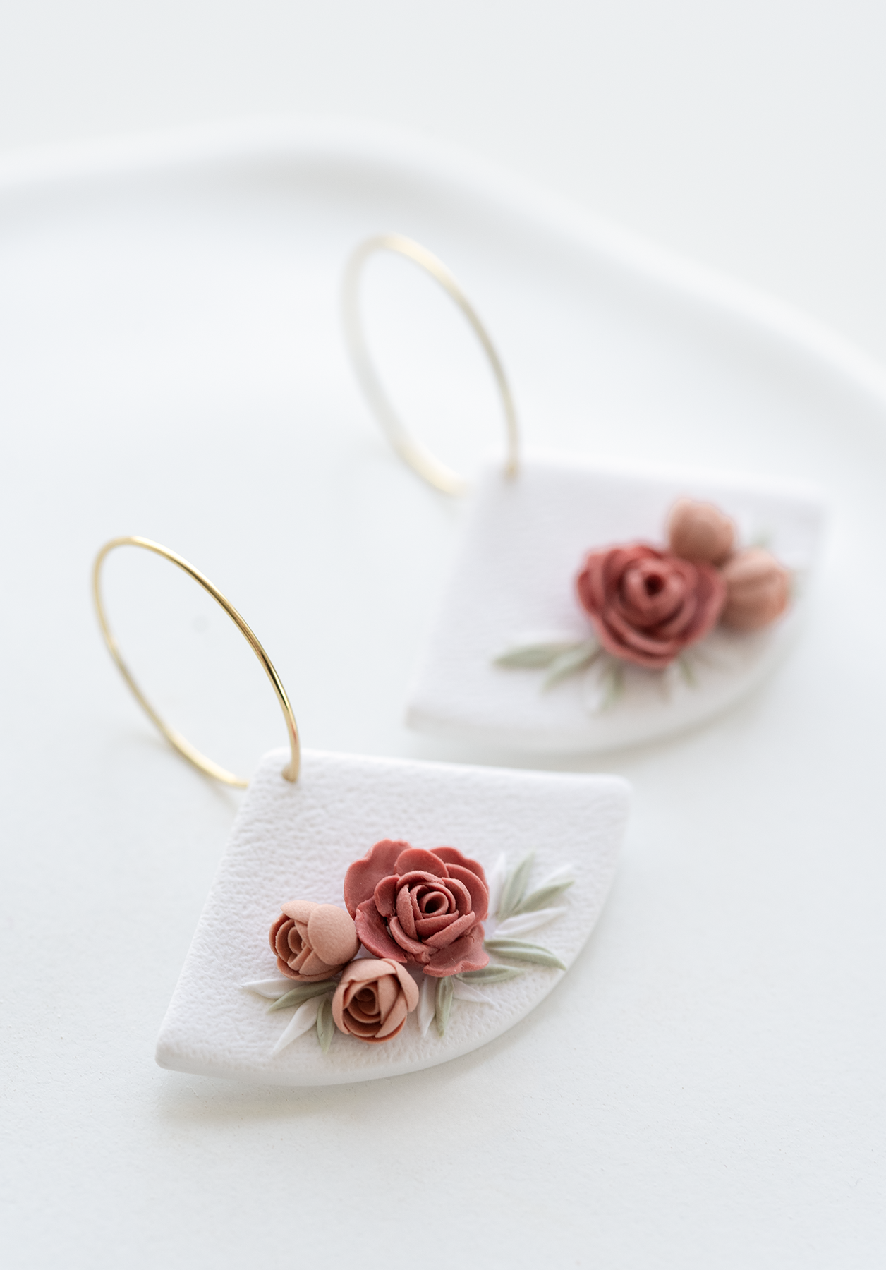 ROSE GARDEN romantic earrings with hand-sculpted floral design on white background, perfect for weddings and everyday. Inspired by nature, made in Dubai.