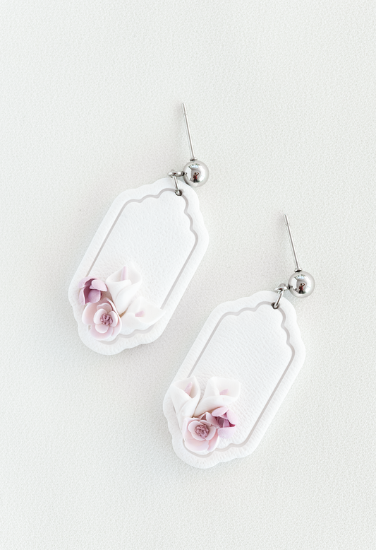 Pair of earrings with floral design on a light background, flower earrings, perfect for weddings and everyday wear.