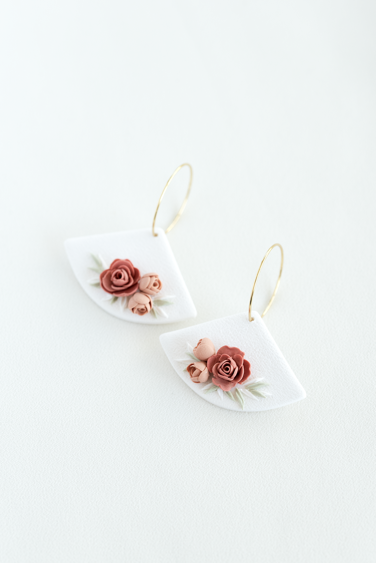 Pair of earrings with floral design on a white background, flower earrings, perfect for weddings and everyday wear.